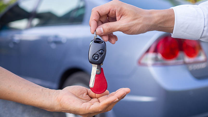 keys being handed over for a car - auto insurance coverage