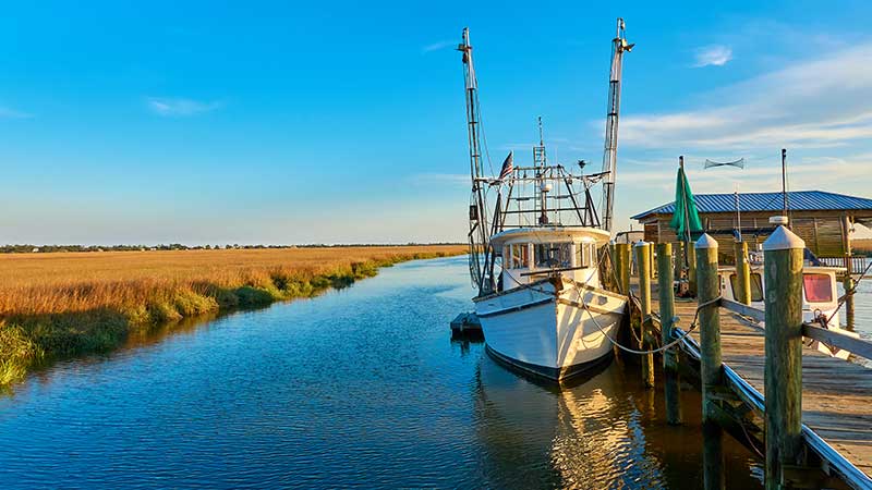 an older boat sits at a dock, and its owners must have considered boat insurance for older boats