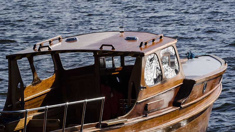 a classic boat floats on open water