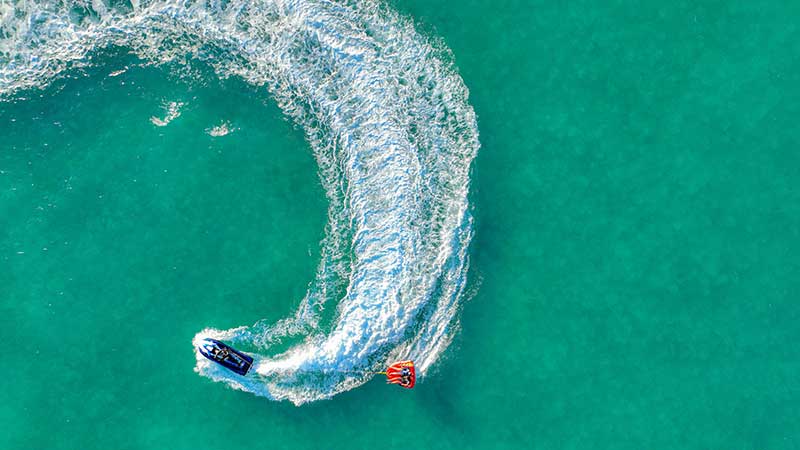 a speed boat curves through still water