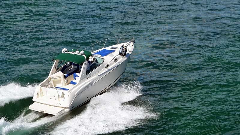 a speed boat makes its way across water