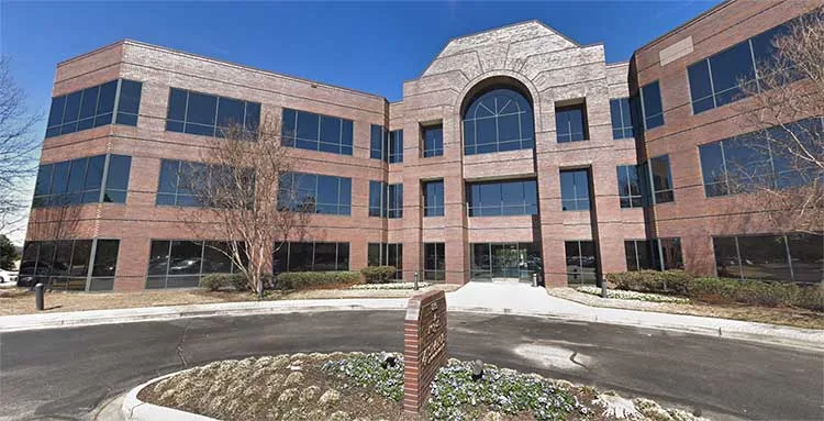 Three-story brick office building at 8295 Tournament Drive in Memphis, Tennessee, for Peachy Insurance.