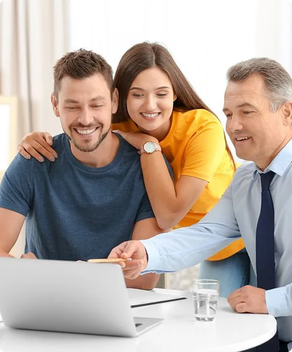 A picture of a loving family. Mom and dad hold their giggling children. This is meant to show the peace of mind given by home insurance.