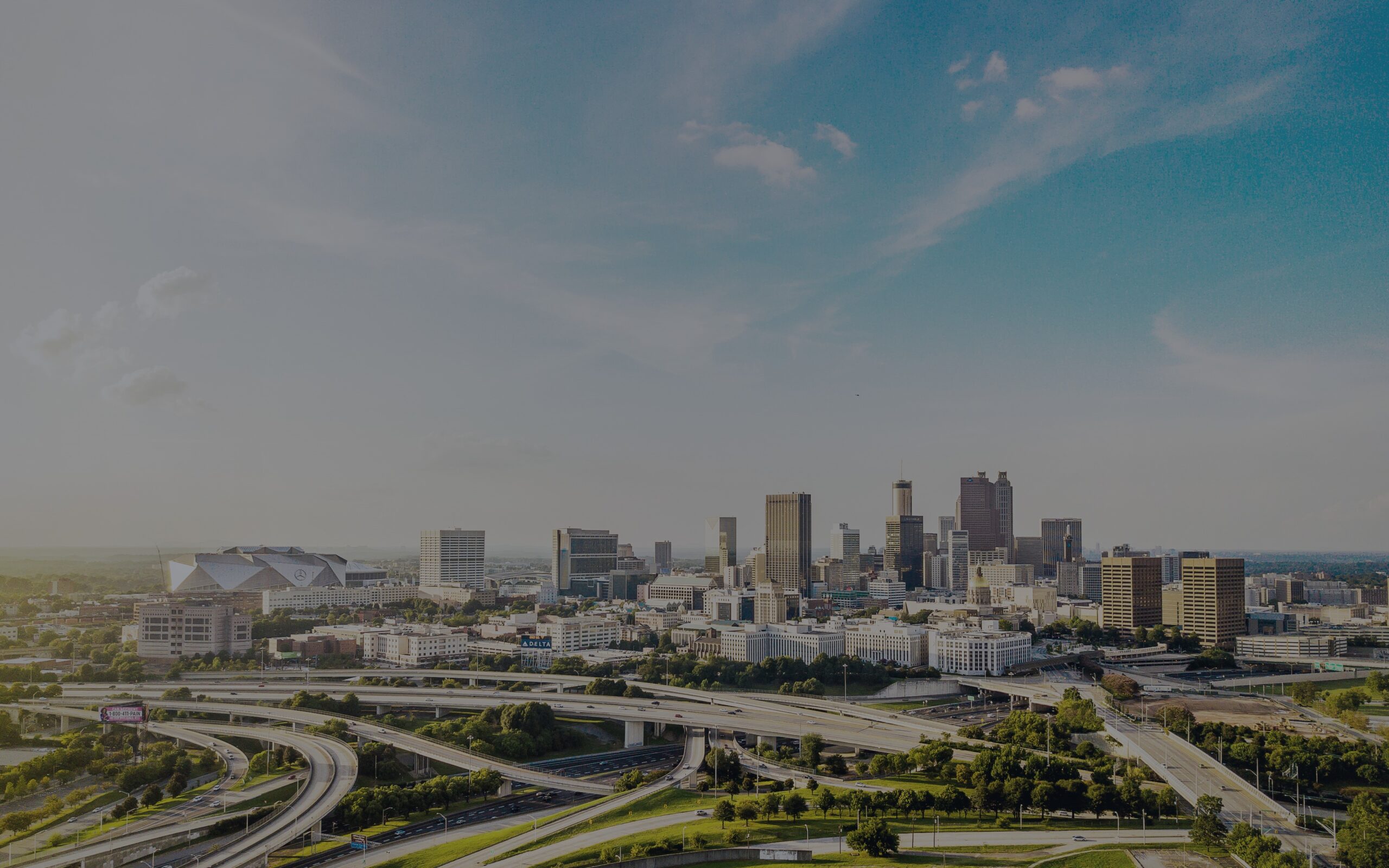 Aerial daytime view of downtown Atlanta skyline with highway interchanges in the foreground