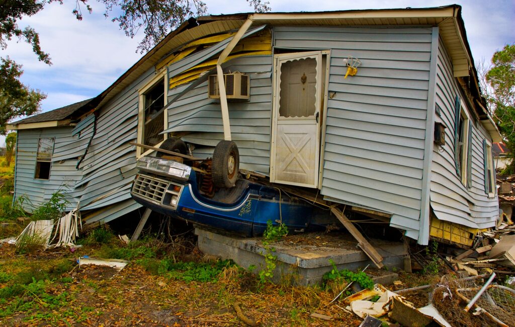 Landlord inspecting a rental property affected by severe weather, highlighting hurricane damage, flood risk, and vacancy concerns for rental properties.