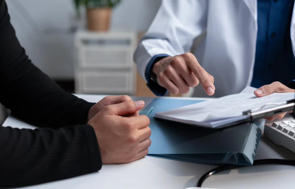 Homeowner discussing liability coverage and umbrella insurance options with an insurance agent during a personalized coverage review.