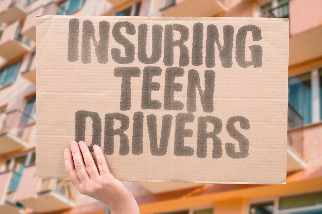 Teen driver and parent reviewing insurance discounts for good grades, safe driving, telematics, and bundled home and auto coverage.