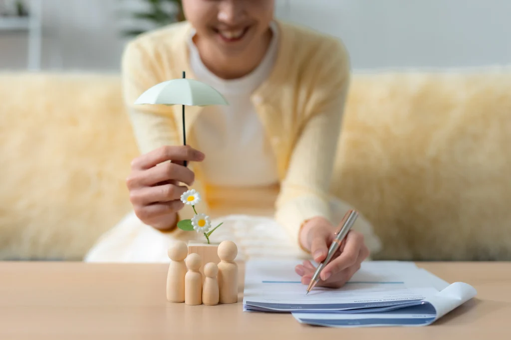 Homeowner meeting with an insurance agent to review liability limits, assets, underlying policies, and umbrella insurance options.